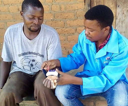 Armed with a blood pressure machine, a community health worker saves a patient’s life in rural Zambia