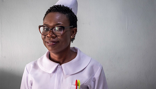 Photo of a Nigerian nurse wearing a uniform and glasses