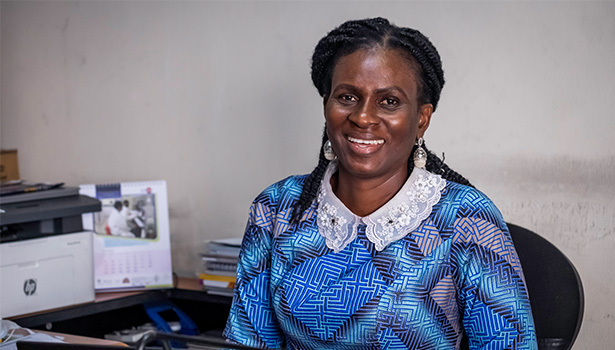 Photo of a smiling Nigerian woman in an office.