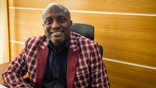 Photo of a smiling Nigerian man in an office