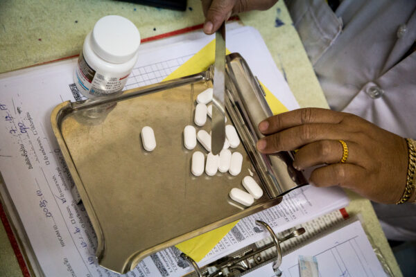 Doctor sorting out HIV medication on tray