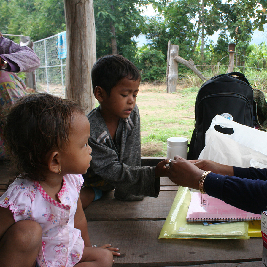 Nurse performing a finger prick test on a patient