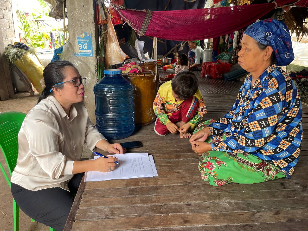 Community health worker in Cambodia interviews woman on her cooking practices