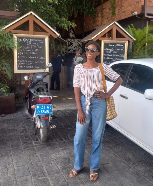 CHAI SRH Analyst, Mariama Faty poses in front of a white salon car